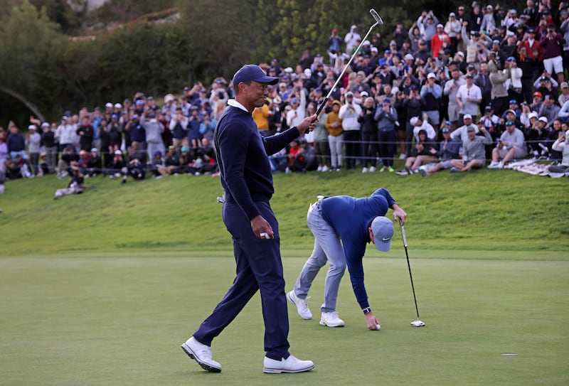 Tiger Woods reacts after making birdie on the 18th green during the first round of the the Genesis Invitational. AFP