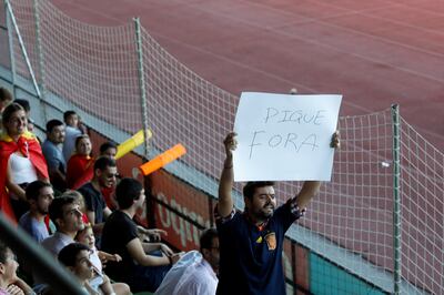 A man displays a banner that reads "Pique Out", referring to Spain's player Gerard Pique, before a training session in Las Rozas, near Madrid, Spain, October 2, 2017. REUTERS/Rafael Marchante