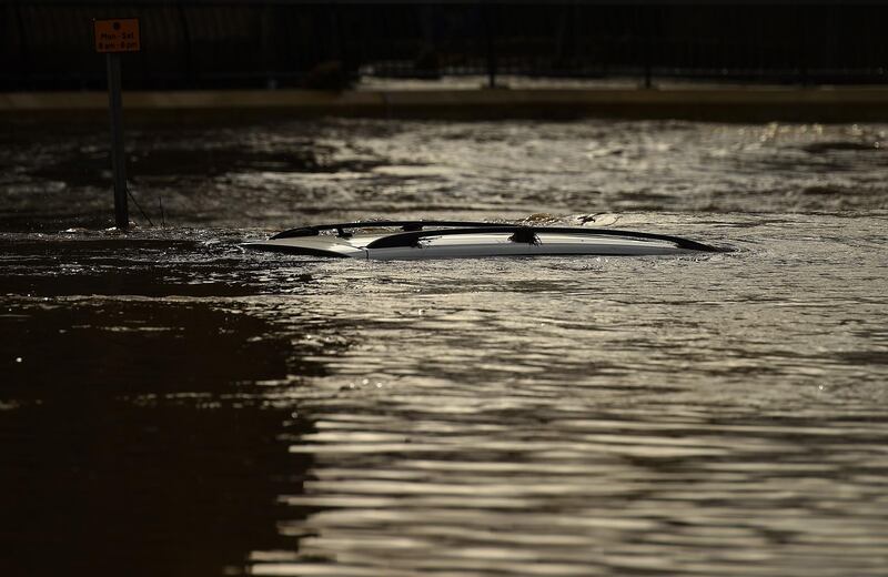 The roof of a submerged car is pictured in a flooded street in Mytholmroyd, northern England, after the River Calder burst its banks as Storm Ciara swept over the country.   AFP