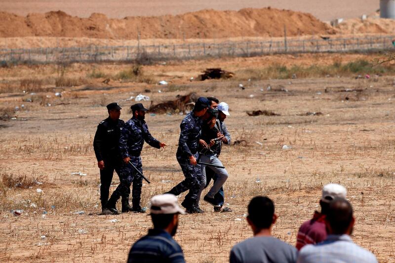 Palestinian Hamas police block protesters from reaching the border fence east of Khan Yunis in the southern Gaza Strip. AFP