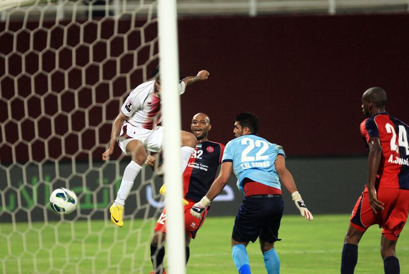 ABU DHABI - UNITED ARAB EMIRATES - 10OCT2012 - AL Wahda's Salem Salah, left, in white, scores the third goal against Al Shaab during Etisalat Cup match yesterday at Al Wahda club in Abu Dhabi. Ravindranath K / The National 