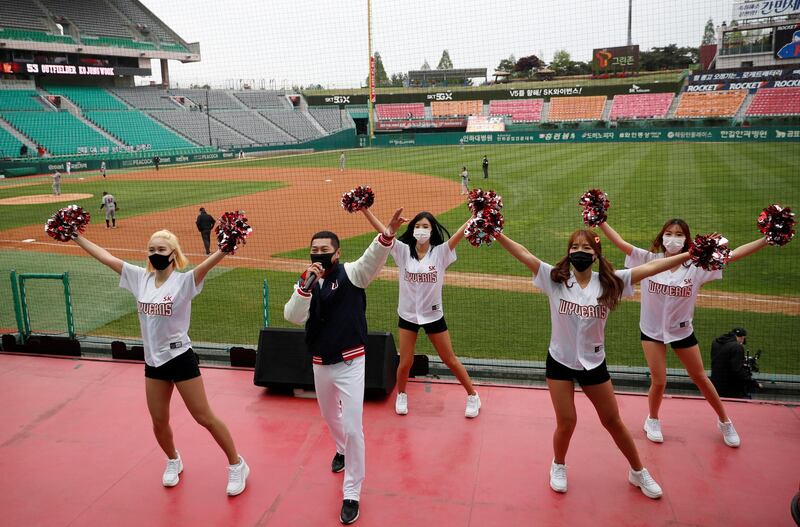 A cheering group in South Korea wave pompoms to an empty stadium as sports leagues starts behind closed doors. Reuters