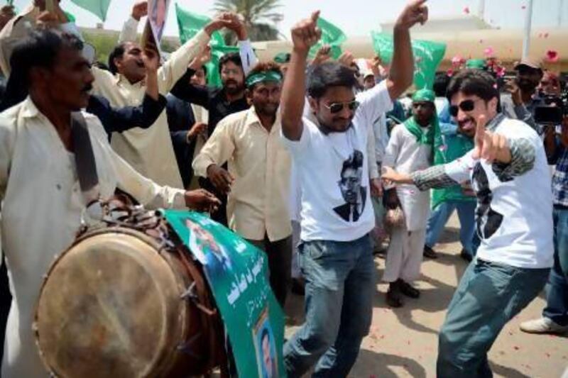 Supporters of Pakistan's former military ruler Pervez Musharraf celebrate his homecoming outside the airport in Karachi.