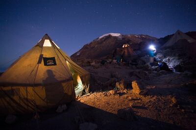 ADP5TW Africa Tanzania Kilimanjaro National Park Climbing partys tents glow before dawn summit departure from Barafu Camp. WorldFoto / Alamy Stock Photo