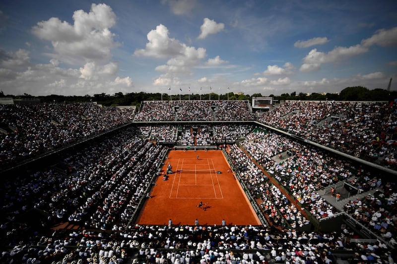 (FILES) In this file photo taken on June 8, 2018 Spectators watch Spain's Rafael Nadal (TOP) as he plays Argentina's Juan Martin del Potro during their men's singles semi-final match on day thirteen of The Roland Garros 2018 French Open tennis tournament in Paris. Roland-Garros, was postponed from the spring 2020 to the autumn 2020 due to the novel coronavirus pandemic. Because the COVID-19 is a source of "uncertainty for all events bringing together audiences all over the world", the the Federation French tennis (FFT) announced on May 7, 2020 that "all tickets already purchased" for the French Open tennis tournament will be refund. / AFP / CHRISTOPHE SIMON
