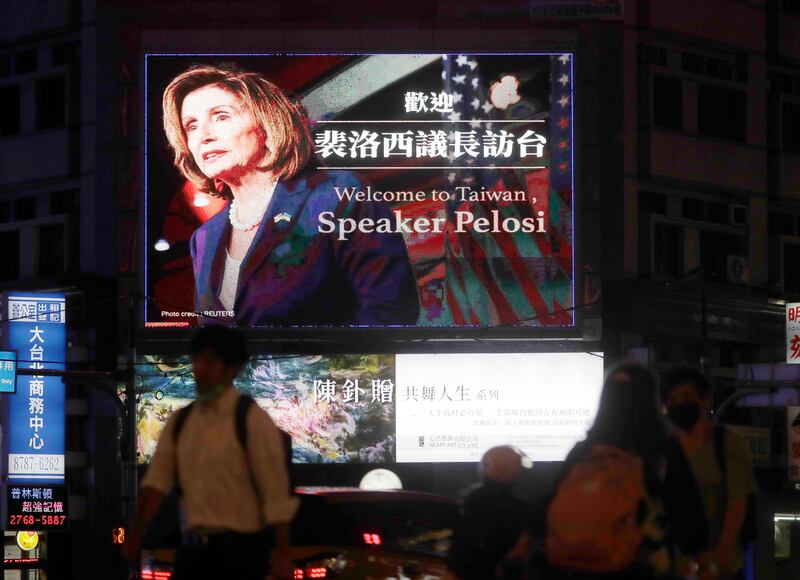 People walk past a billboard welcoming US House Speaker Nancy Pelosi in Taipei, Taiwan.  AP