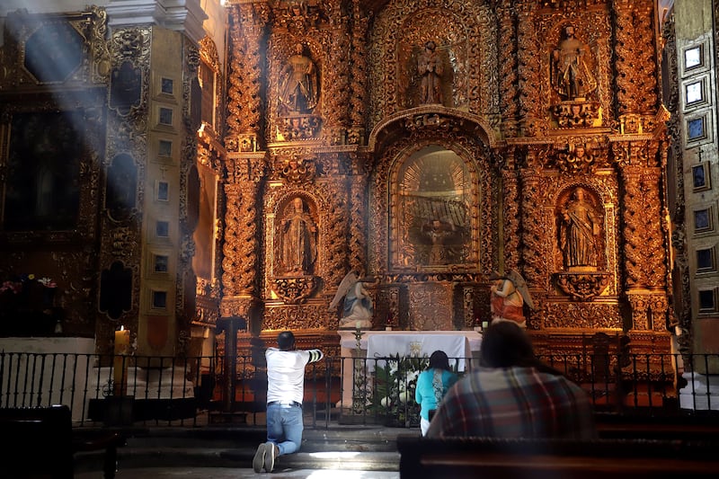 Catholic parishioners pray in the Franciscan Conventual Complex Cathedral of Our Lady of the Assumption, in the state of Tlaxcala, Mexico. The Franciscan Conventual Complex The Monastery and Cathedral of Our Lady of the Assumption of Tlaxcala, central Mexico, has been listed as a Unesco World Heritage site.