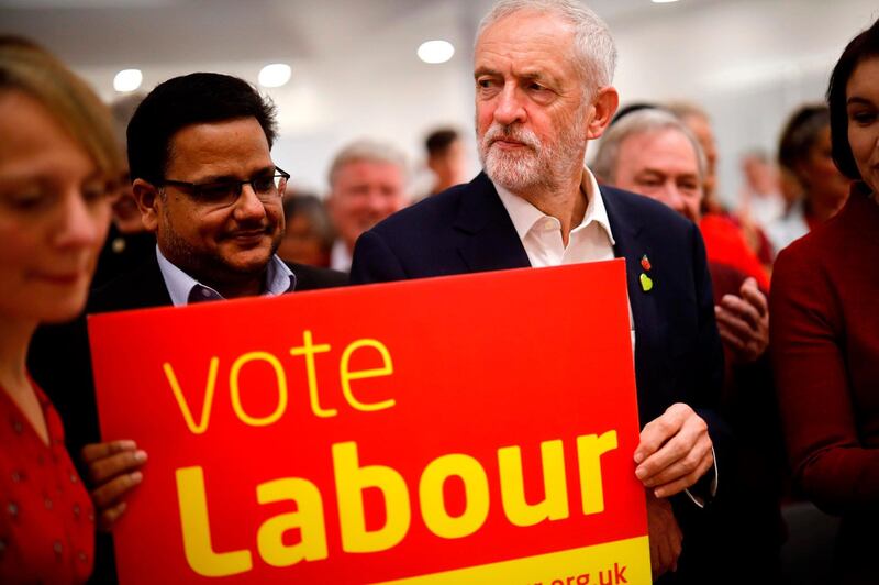 Britain's Labour Party leader Jeremy Corbyn holds a placard at a campaign event in Milton Keynes, southern England on October 31, 2019. Britain will go to the polls on December 12 in a bid to unlock the protracted Brexit deadlock. / AFP / Tolga Akmen
