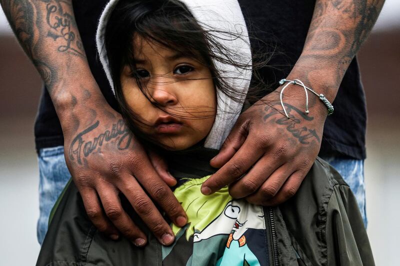 Brooklyn Centre resident Jose Chavez wraps his arms around his daughter Cattleya Chavez, 3, during a protest outside the Brooklyn Centre Police Department, in the US, days after Daunte Wright was shot and killed by a police officer. Reuters