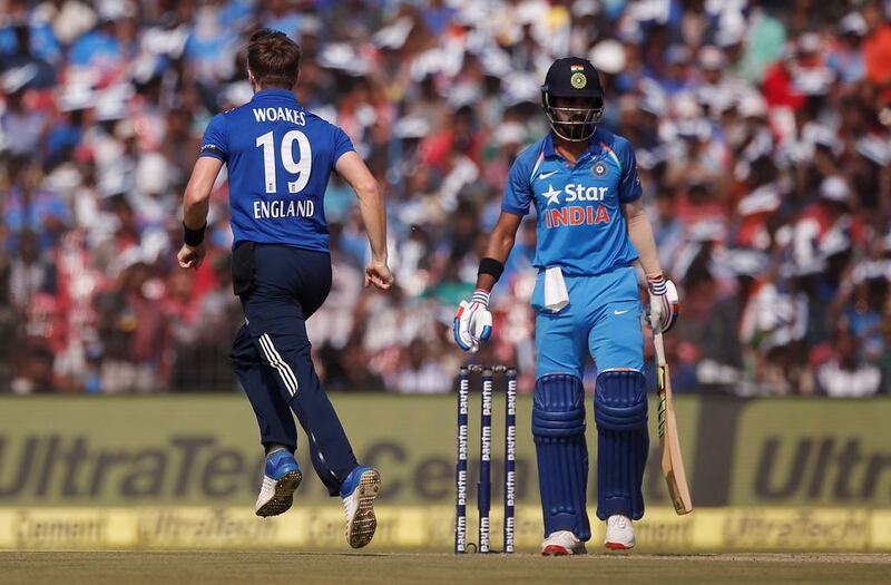 England medium pacer Chris Woakes, left, celebrates the dismissal of India opening batsman Lokesh Rahul. Adnan Abidi / Reuters