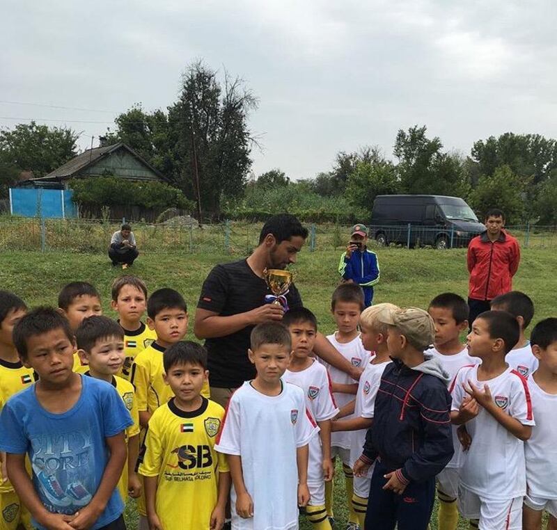 Salem Alkarbi hosts events for disadvantaged children worldwide through his football charity "Beyond the Boundaries of Football". Here he is in Kirghistan. Courtesy Salem Alkarbi