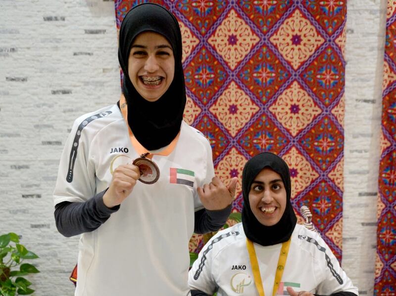 Noura Al Ketbi, left, celebrates gold with bronze-medallist Thekra Al Kaabi at the World Para Athletics Grand Prix in Dubai. Photo: Dubai Club for People of Determination