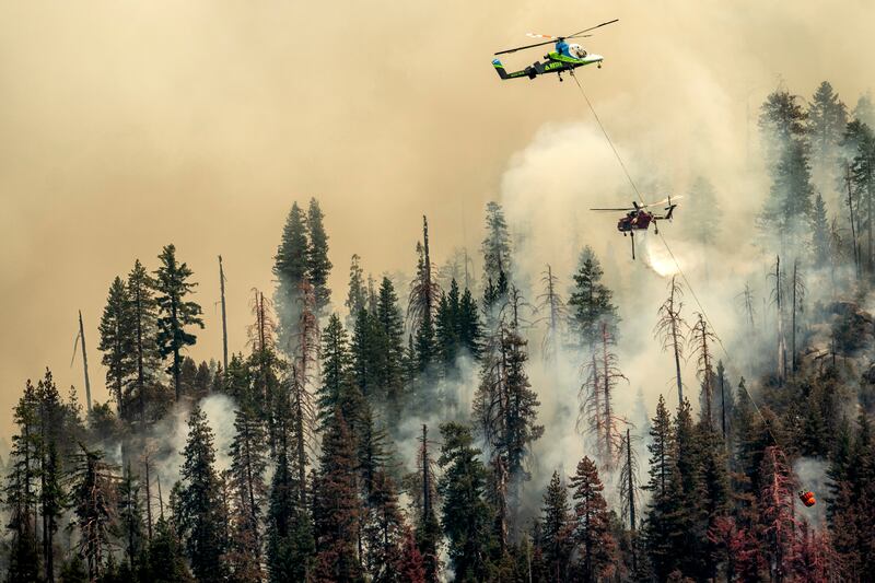 Helicopters drop water on the Washburn fire. AP