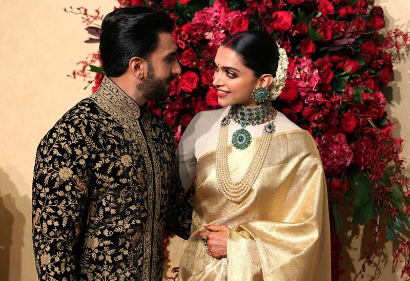 While the couple wore bold red designs at their Italian wedding, they opted for refined gold, black and green for their Indian party.