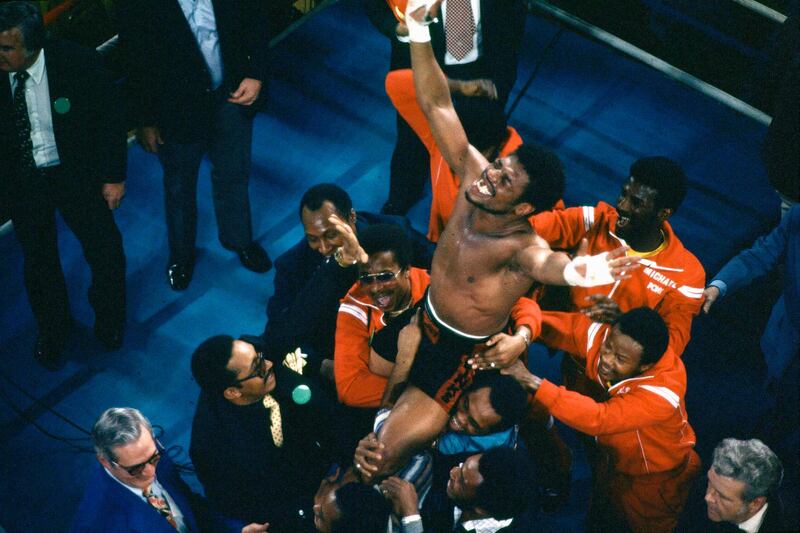 Leon Spinks celebrates as his entourage holds him aloft after his 15-round split decision victory over world heavyweight boxing champion Muhammad Ali in Las Vegas on February 15, 1978. AP