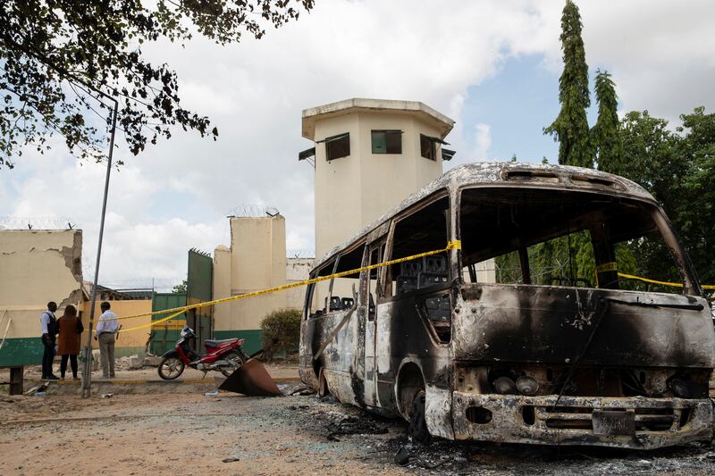 A burnt-out vehicle at the entrance to the prison after the attack by gunmen in Kuje. Reuters