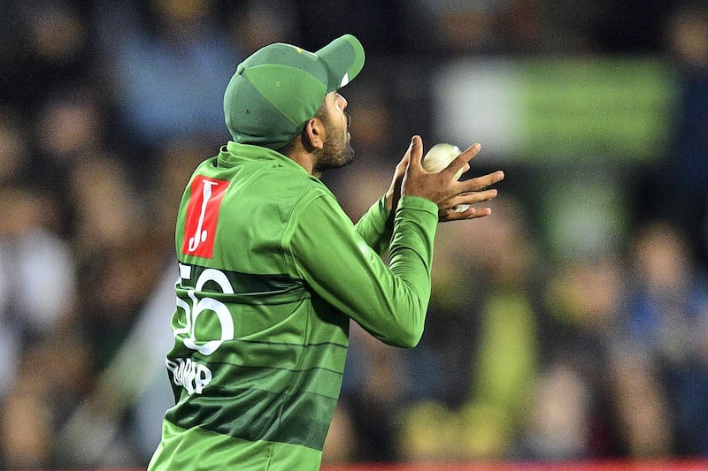 Pakistan's fielder Babar Azam takes a successful catch to dismiss Aaron Finch of Australia during the second Twenty20 match between Australia and Pakistan at the Manuka Oval in Canberra on November 5, 2019. (Photo by Saeed KHAN / AFP) / IMAGE RESTRICTED TO EDITORIAL USE - STRICTLY NO COMMERCIAL USE