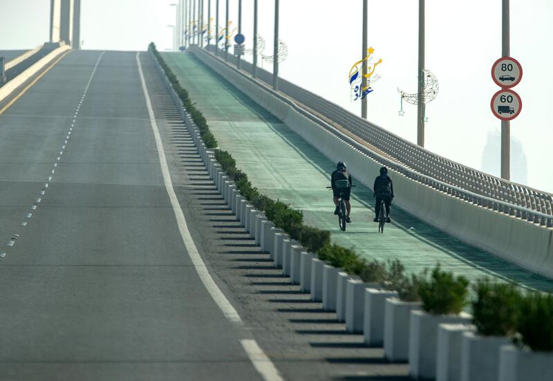 Cyclists at Al Hudayriat Island during a hazy morning on May 19, 2021. Victor Besa / The National.
For: Stand Alone / Weather