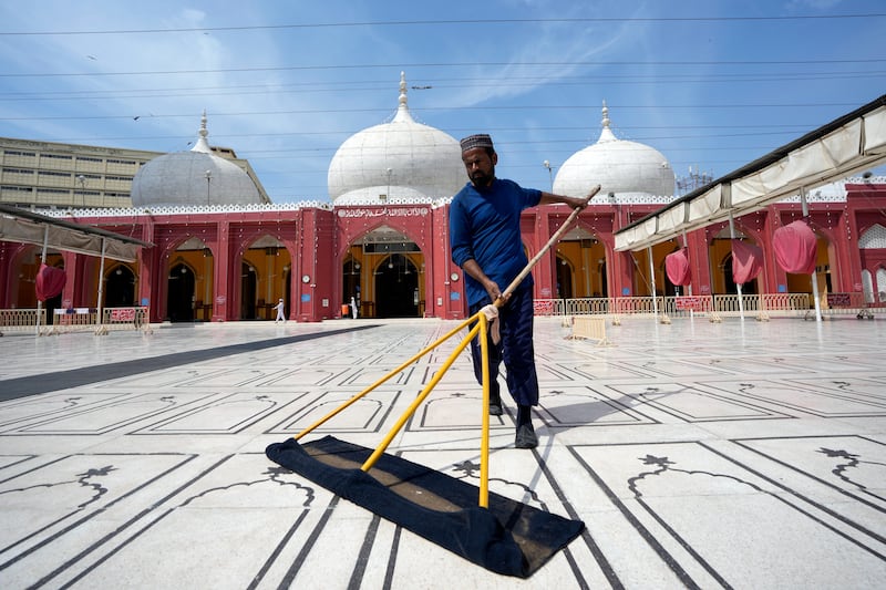 A Pakistani man cleans a mosque in Karachi, Pakistan. AP