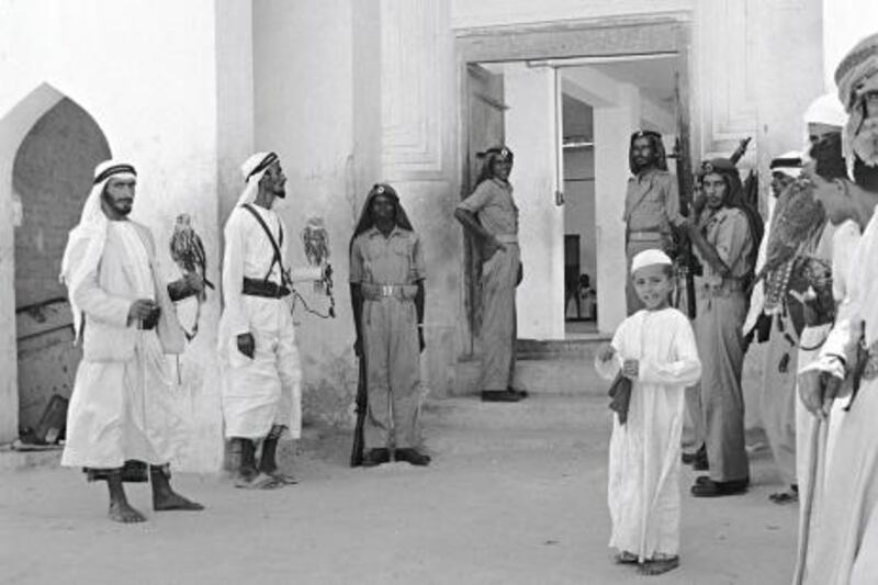 Falconers and guards inside Qasr Al Hosn, 1962. Sheikh Shakhbut would receive visitors in his majlis after the asr prayer. Guy Gravette.