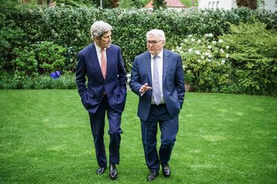 BERLIN, GERMANY - MAY 17:  In this handout photo provided by the German Government Press Office (BPA), German President Frank-Walter Steinmeier (R) talks to US Envoy for Climate State John Kerry in the garden of his villa during a private dinner on May 17, 2021 in Berlin, Germany.  (Photo by Jesco Denzel/Bundesregierung via Getty Images)