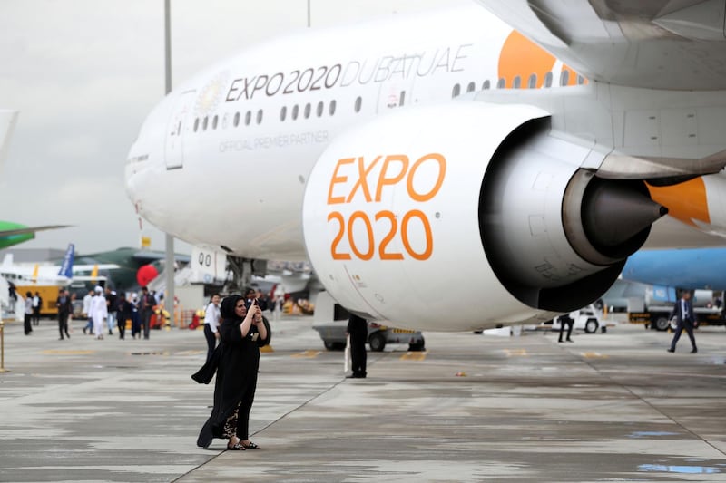 Dubai, United Arab Emirates - November 20, 2019: A visitor takes a picture near a Boeing 777 at the Dubai airshow. Wednesday, November 20th, 2017 at Dubai Airshow, Dubai. Chris Whiteoak / The National