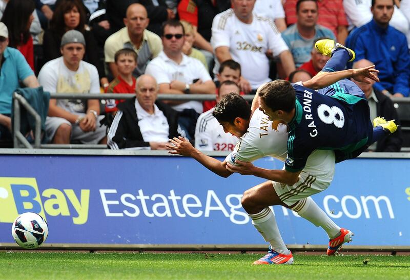 SWANSEA, WALES - SEPTEMBER 01: Neil Taylor of Swansea City is tackled by Craig Gardner of Sunderland during the Premier League match between Swansea City and Sunderland at Liberty Stadium on September 1, 2012 in Swansea, Wales. (Photo by Tom Dulat/Getty Images) *** Local Caption ***  151104245.jpg