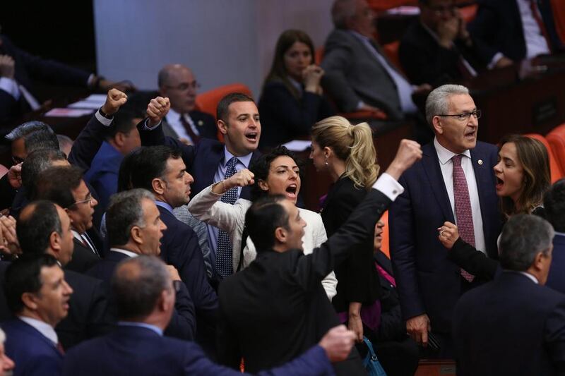 Turkish lawmakers shout slogans ahead of a vote on a bill to remove immunity for lawmakers on Friday. EPA/STR