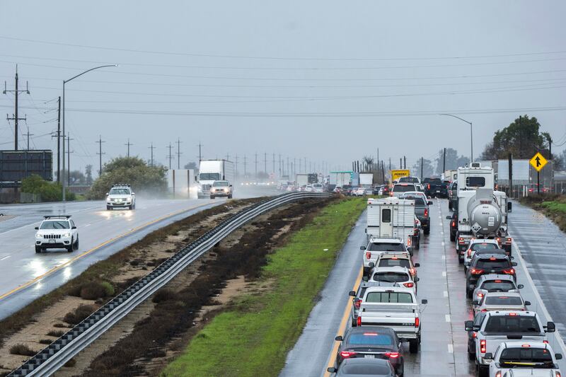 Cars are stopped in the northbound lanes of Highway 101 after flooding closed the major road near Chualar, California. AP
