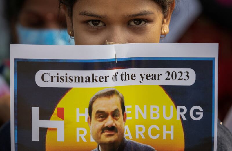 An activist holds a placard denouncing billionaire Gautam Adani during a protest in New Delhi. Reuters