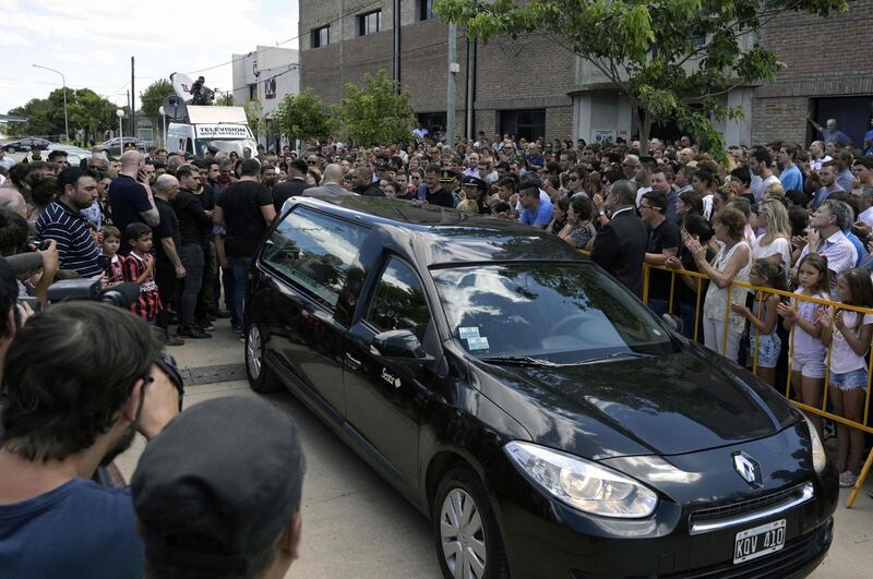 People surround the hearse carrying the coffin of Emiliano Sala. AFP