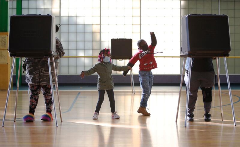 Children entertain themselves while their mother and grandmother vote at a polling location in Cleveland Ohio. EPA