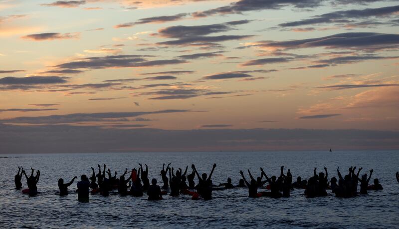 Members of Wild Sea Women take part in a Wild Kundalini Yoga class during solstice sunrise in Seaburn, Sunderland, north-east England. Reuters