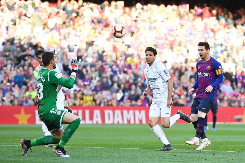 Lionel Messi chips the goalkeeper in an attempt to score. Getty Images