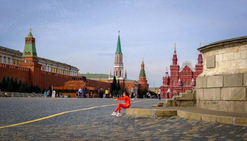 A woman sits on the steps of Lobnoye mesto (the ancient place of execution) at Red square in downtown Moscow on September 17, 2020. (Photo by Yuri KADOBNOV / AFP)