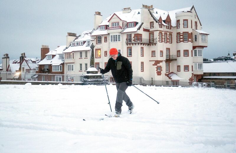 Sarah Wolffe skis through the snow across the Esplanade at Edinburgh Castle, Scotland, Thursday, Jan. 21, 2021 as storm Christop brings in challenging weather conditions. (Jane Barlow/PA via AP)