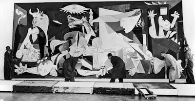 Guernica, perhaps the most famous painting by Pablo Picasso, being hung in the Municipal Museum in Amsterdam for an exhibition in July 1956. Getty Images
