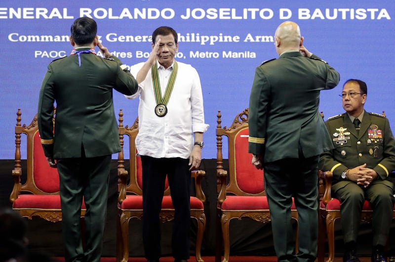 Rodrigo Duterte salutes at Lieutenant General Rolando Joselito D. Bautista and Major General Macairog Sabeniano Alberto, during a change of command ceremonies of the Philippine Army at a military camp in Taguig, south of Manila, Philippines.  EPA