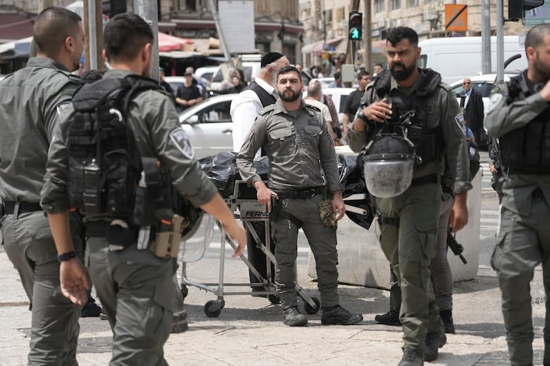 Israeli security forces remove the body of a man shot by police after he stabbed an officer in occupied East Jerusalem's Old City on Tuesday. AP