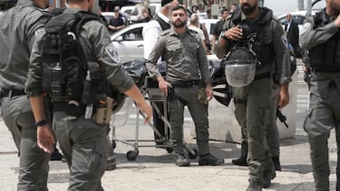 Israeli security forces remove the body of a man shot by police after he stabbed an officer in occupied East Jerusalem's Old City on Tuesday. AP