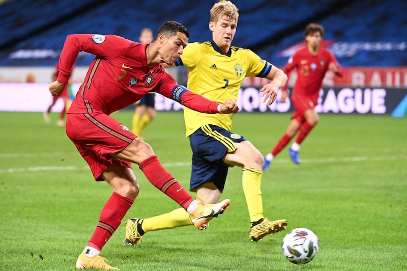Cristiano Ronaldo shoots past Sweden's defender Filip Helander. AFP