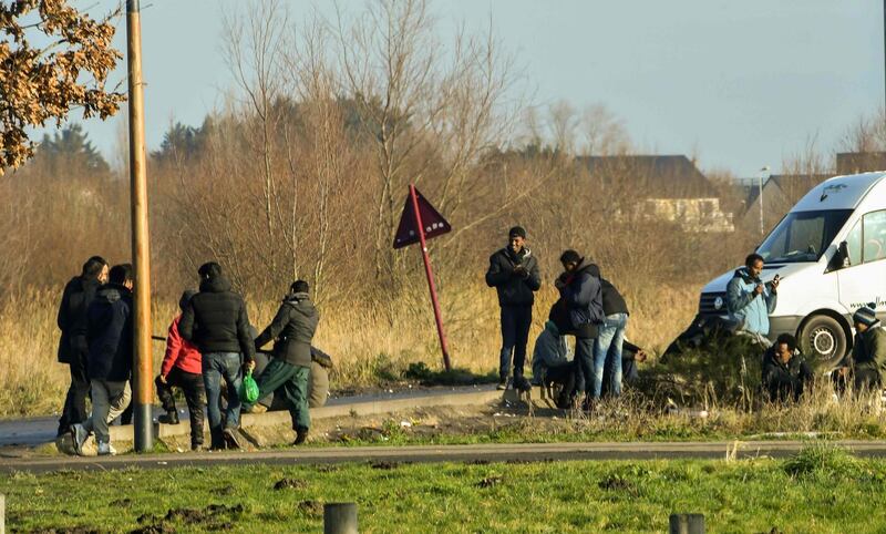 Migrants gather near a truck parking lot close to the N216 highway that leads to the ferry terminal, on January 12, 2018 in Calais.
Asylum claims in France hit a record 100,000 last year, official figures shows early January, as the government draws up hotly-debated new legislation on immigration. / AFP PHOTO / PHILIPPE HUGUEN