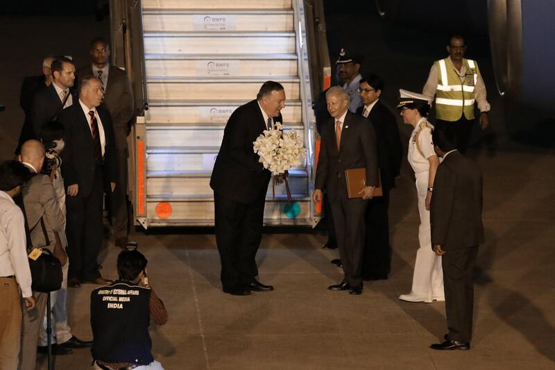 Mike Pompeo receives a bouquet of flowers as he arrives at Air Force Station Palam in Delhi, India. Bloomberg