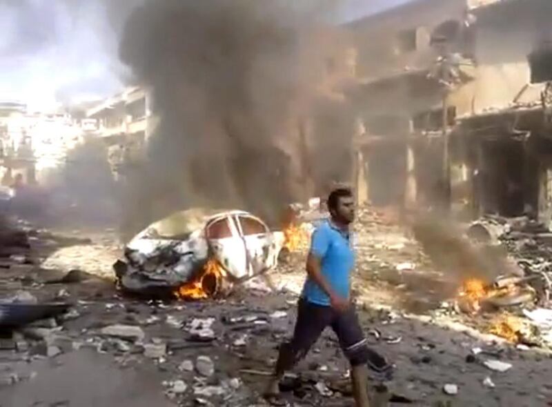 This image grab posted by the Shaam News Network shows the aftermath of a car bomb attack on a market in the town of Darkoush. Shaam News Network via AP