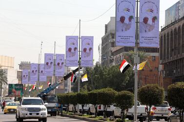 Iraqi and Vatican flags, as well as posters, are being put up in central Baghdad to welcome Pope Francis. EPA