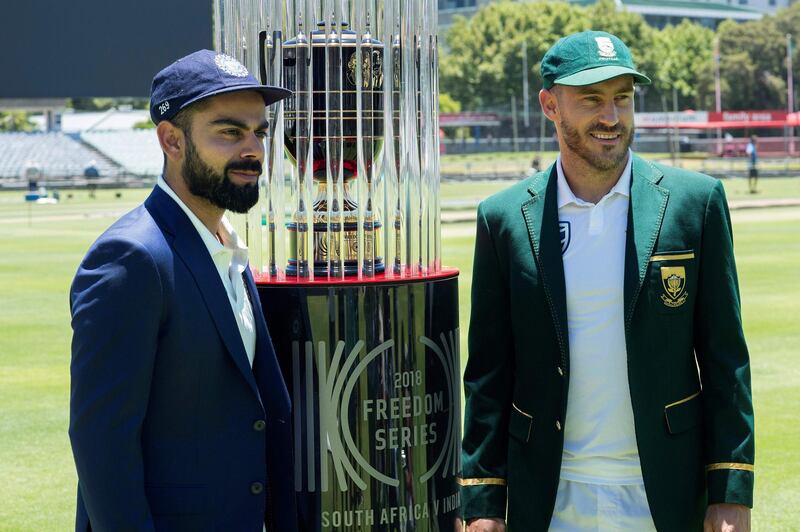 India's captain Virat Kohli(L) and South Africa's captain Faf du Plessis (R) pose with the 2018 Freedom Series trophy, which will be won by the winner of three tests matches between South Africa and India, at the Newlands Cricket ground on January 3, 2018, in Cape Town, prior to the first test match. / AFP PHOTO / RODGER BOSCH