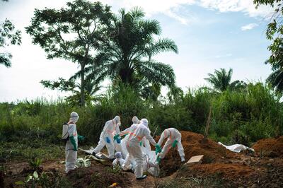 In this Sunday, July 14, 2019 photo, workers bury the remains of Mussa Kathembo, an Islamic scholar who had prayed over those who were sick in Beni, Congo. Kathembo died of Ebola. (AP Photo/Jerome Delay)