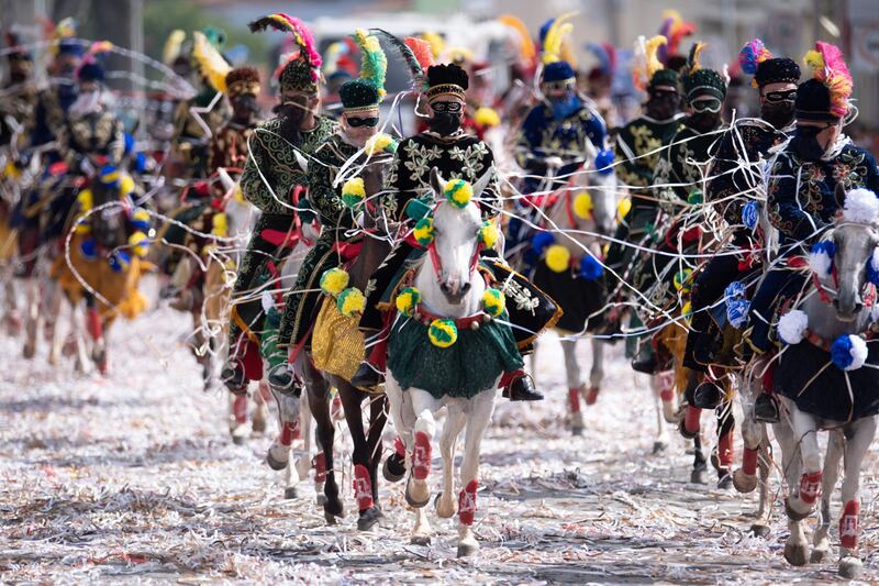 Revellers on horseback take part in a traditional carnival parade in Bonfim, Minas Gerais state, Brazil. AFP