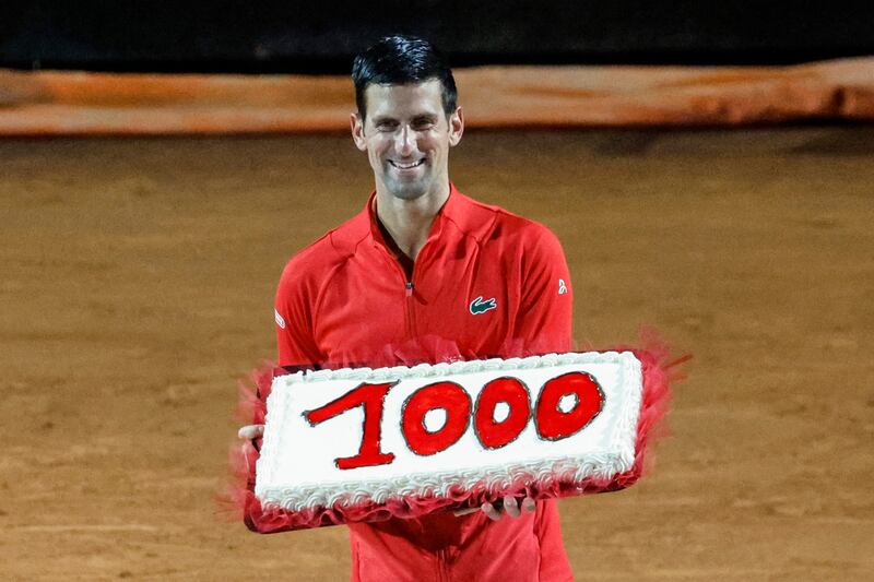 Novak Djokovic holds a cake with the number of his 1,000th tour-level win, earned after beating Casper Ruud in the Italian Open semi-finals in Rome on May 14 2022. EPA