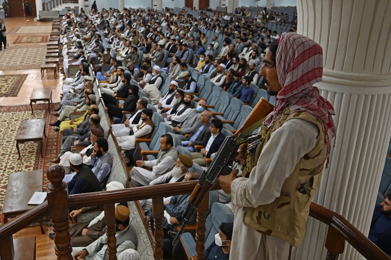 A Taliban fighter guards a consultative meeting on the group's general higher education policies at the Loya Jirga Hall in Kabul on August 29, 2021. AFP